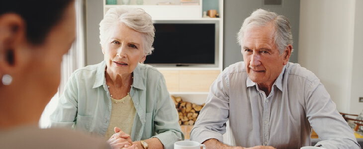 An elderly couple inquiring about wills and trusts with a lawyer