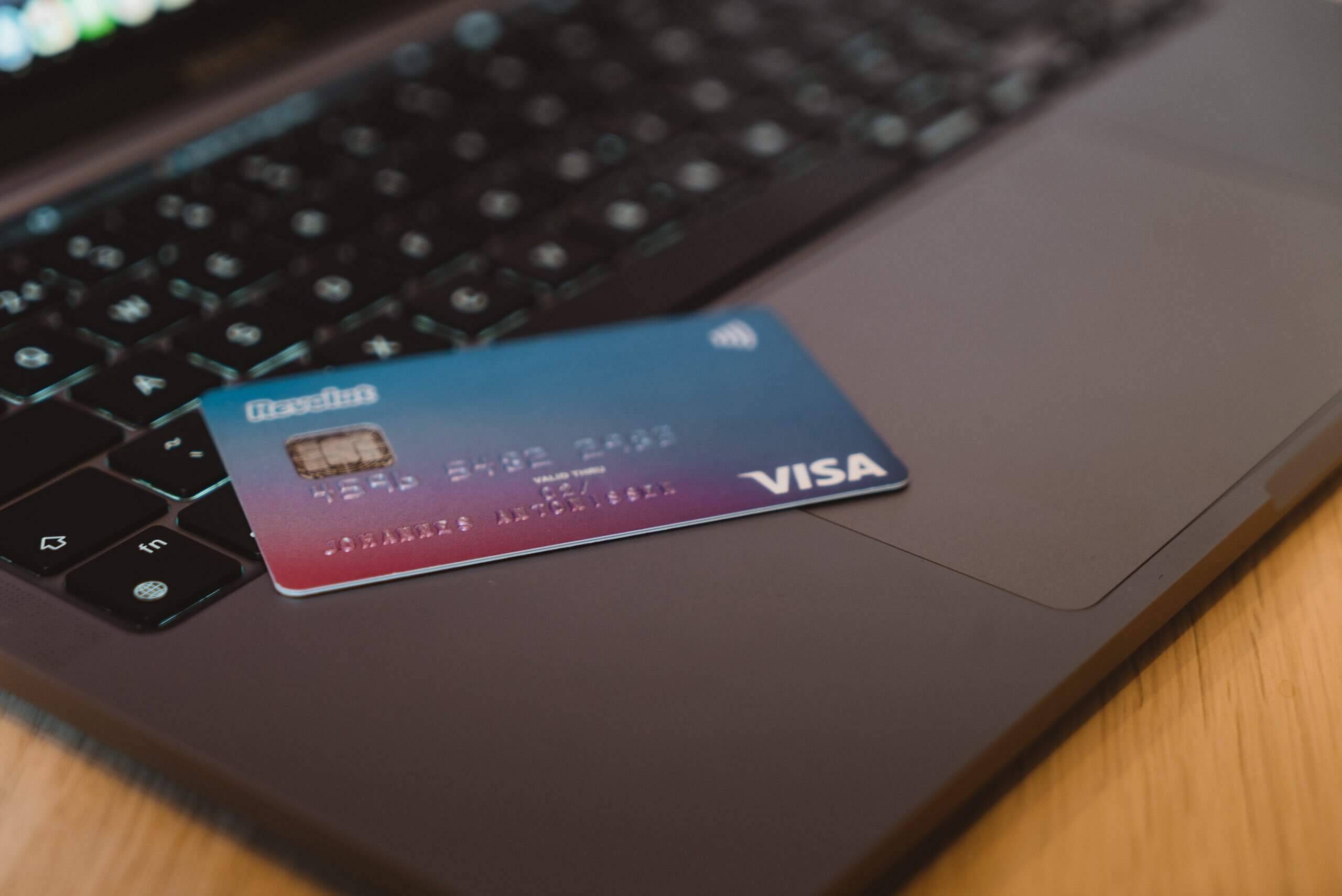 Fraudulent credit card on laptop keyboard