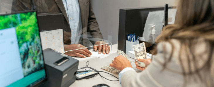Bank teller giving client their money